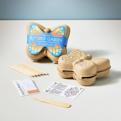 Butterfly-shaped gardening kit with planting sticks and instructions on a light gray background
