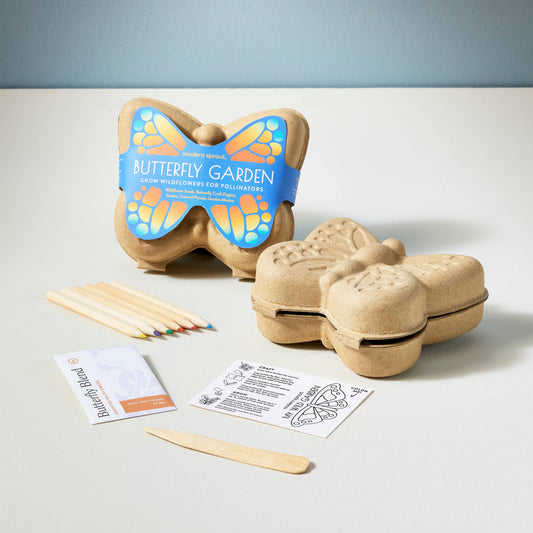 Butterfly-shaped gardening kit with planting sticks and instructions on a light gray background