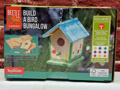 Birdhouse building kit packaging with a brick wall background