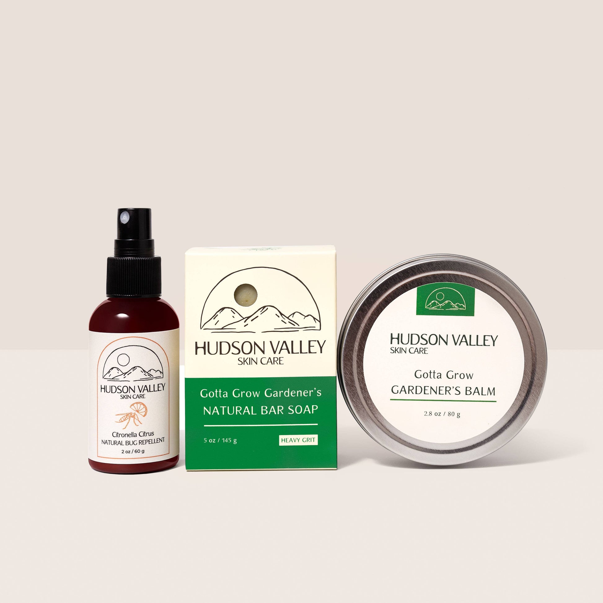 Hudson Valley skin care products including a spray bottle, bar soap, and balm on a light background
