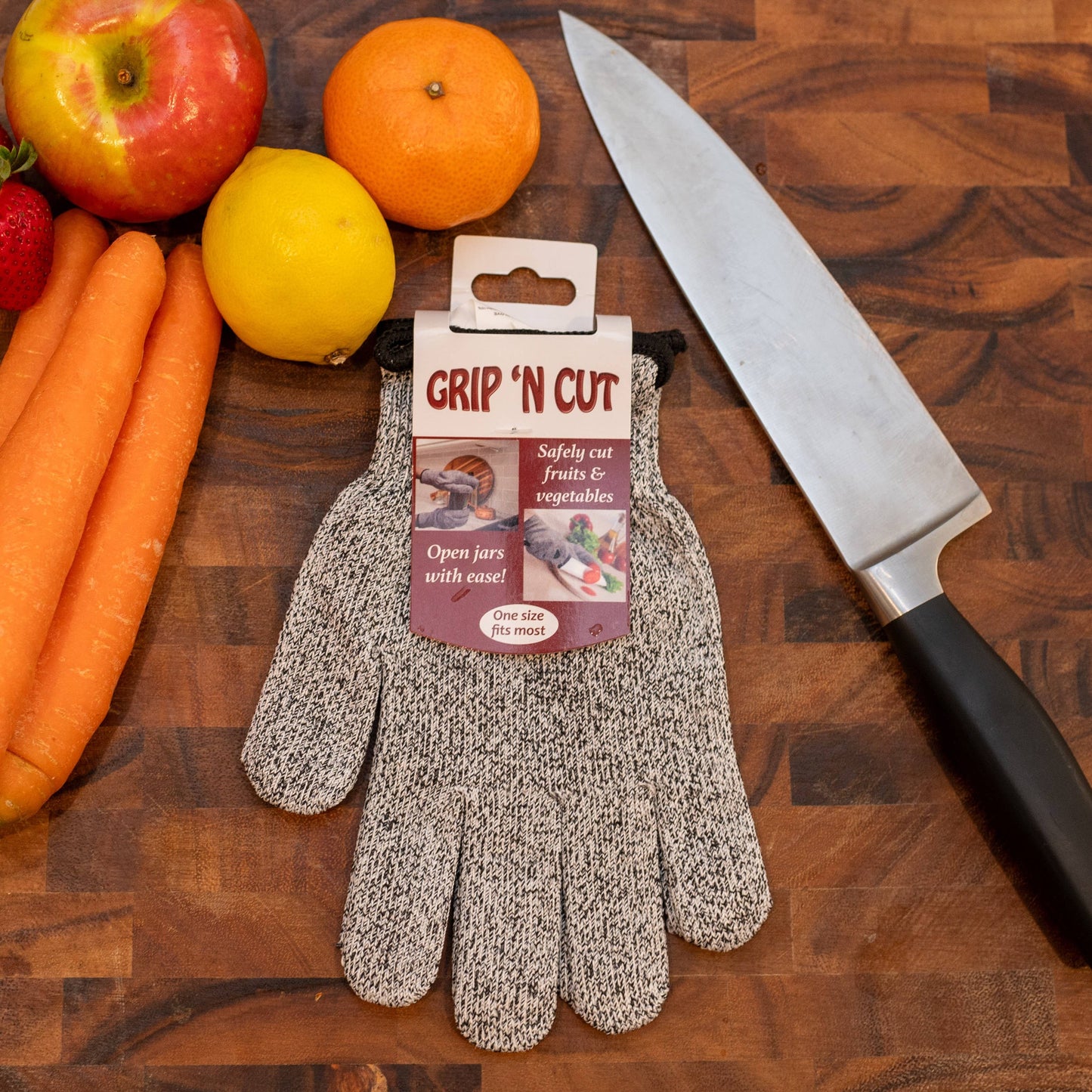 Grip 'N Cut gloves on a wooden surface with fruits and vegetables