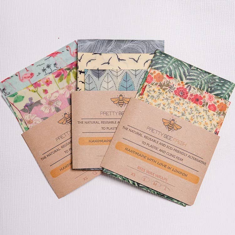 Set of Pretty Bee beeswax wraps with floral and patterned designs on a white background