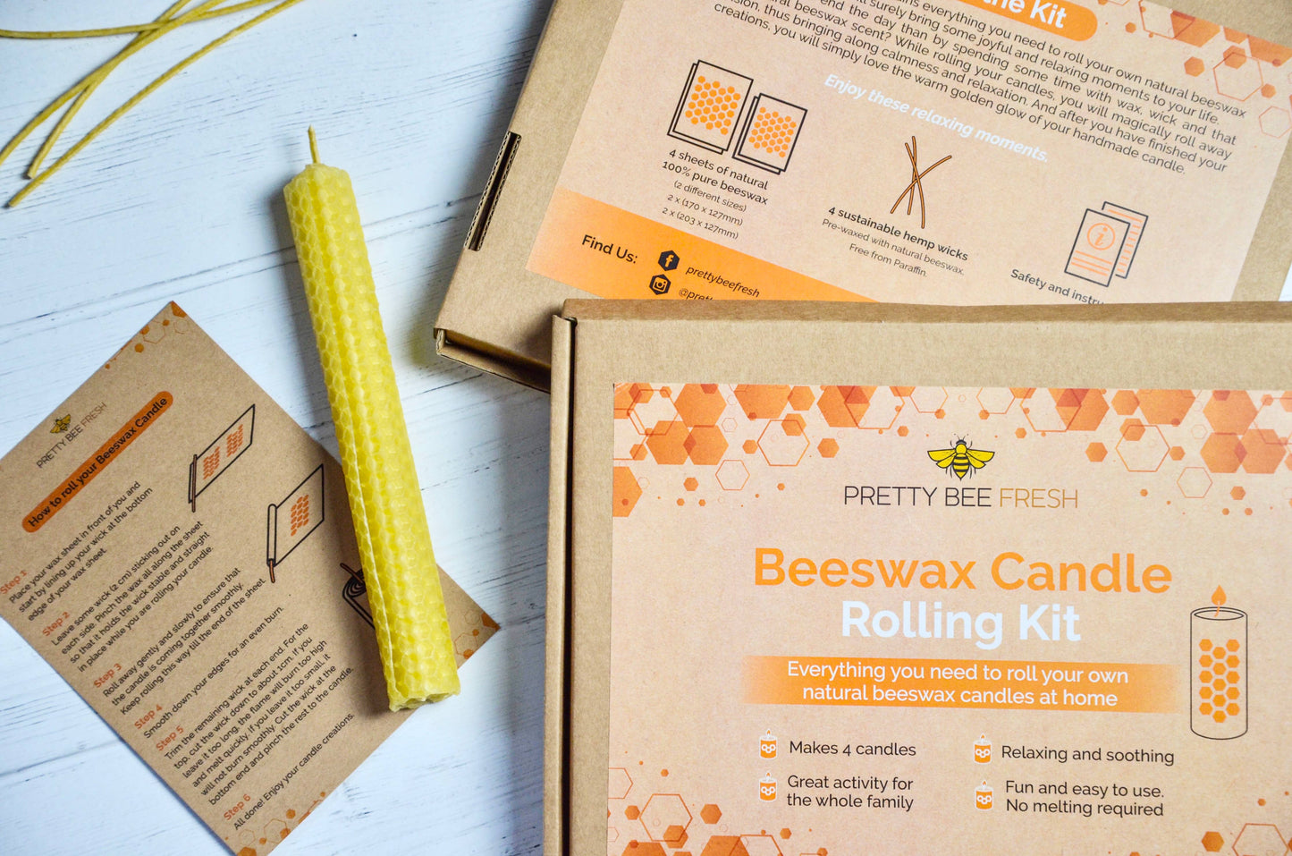 Pretty Bee Fresh Beeswax Candle Rolling Kit with a yellow candle and packaging on a light surface.